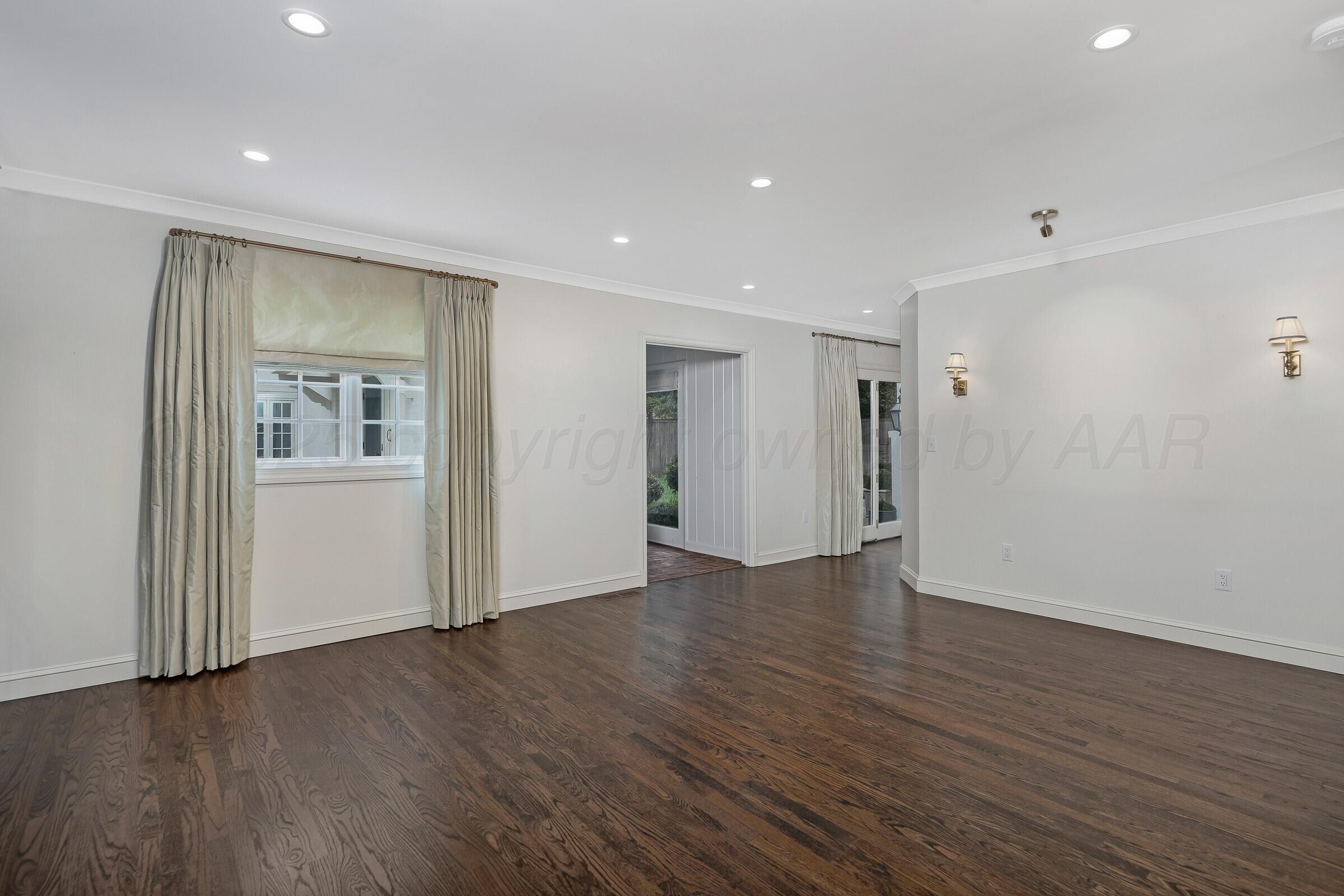 3003 South Hughes Street Amarillo, TX 79109 - Photo 19 of 76 a view of an empty room with wooden floor and closet