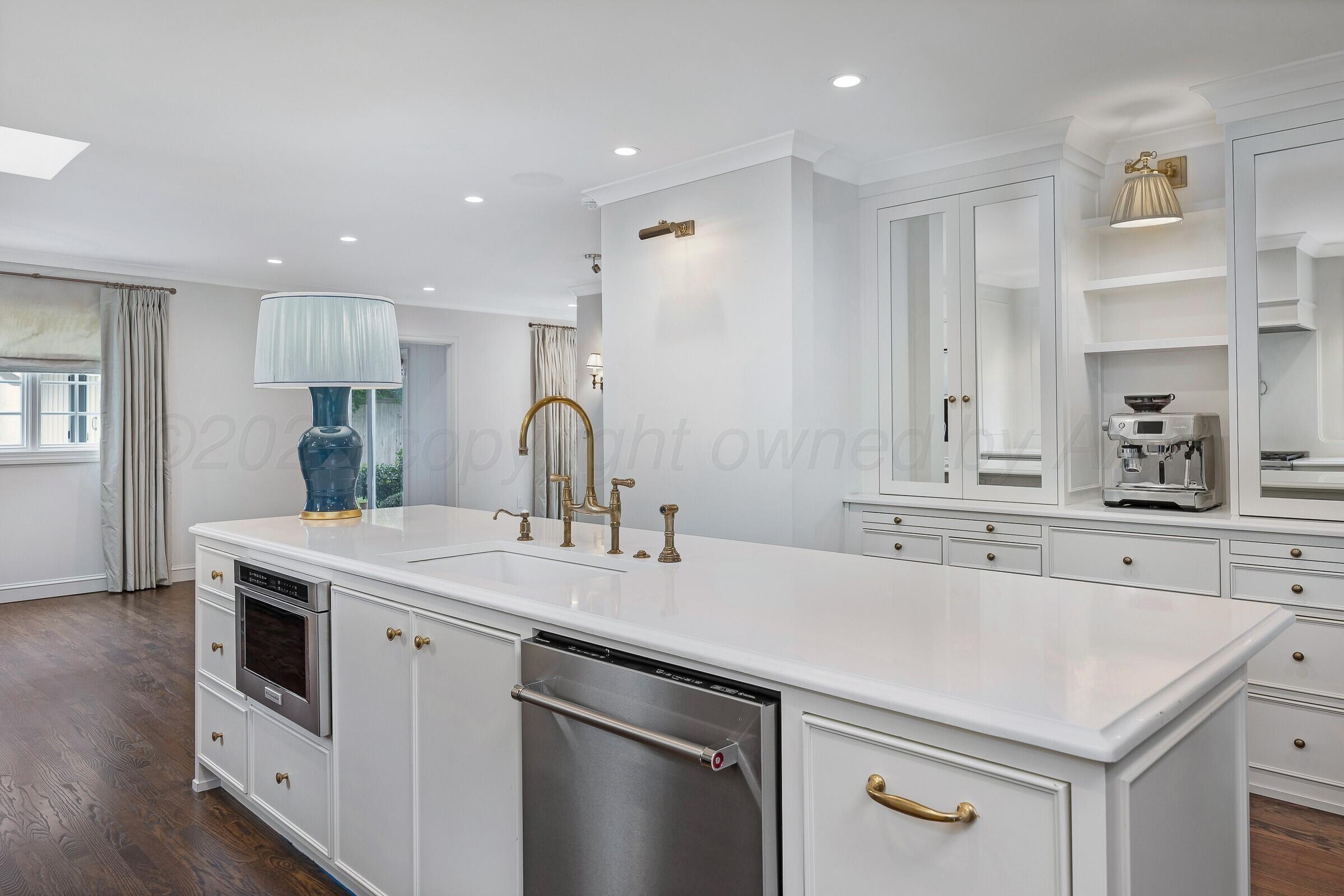 3003 South Hughes Street Amarillo, TX 79109 - Photo 30 of 76 a kitchen with a sink a stove a refrigerator and white cabinets