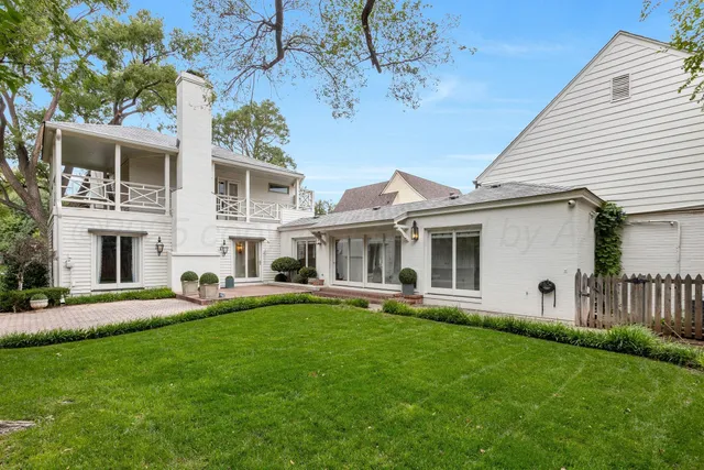 a view of an empty room with wooden floor fireplace and a window