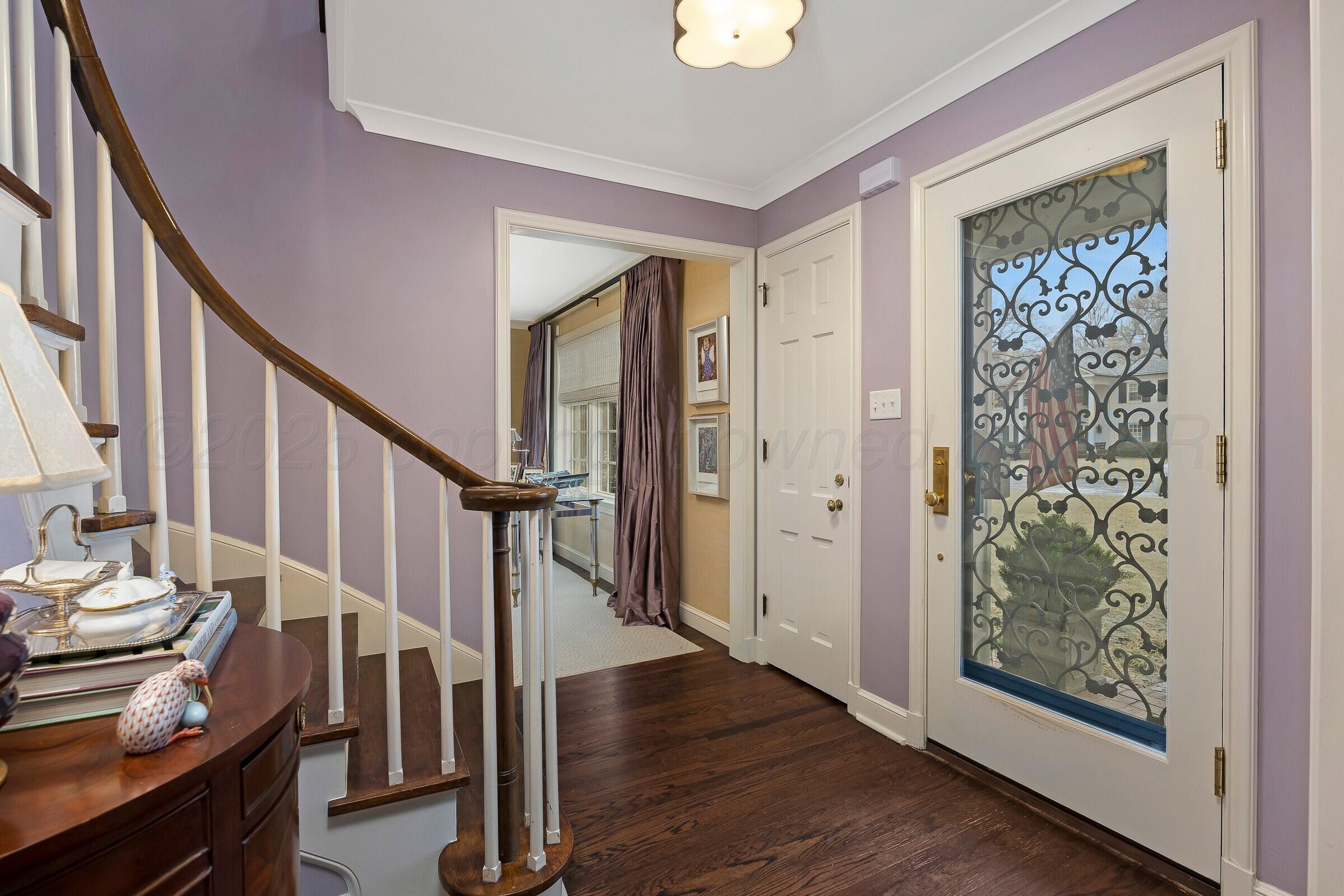 3003 South Hughes Street Amarillo, TX 79109 - Photo 36 of 76 a view of front door with wooden floor and stairs