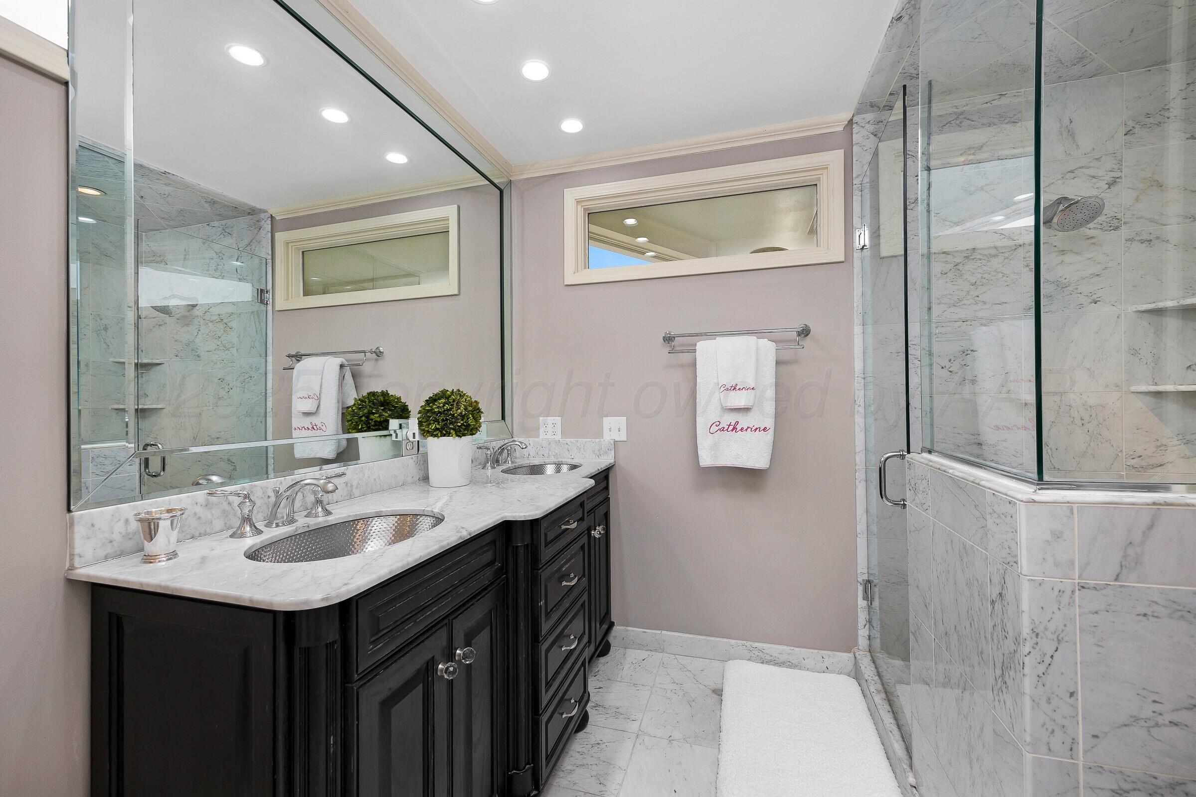 3003 South Hughes Street Amarillo, TX 79109 - Photo 50 of 76 a bathroom with a sink and a mirror