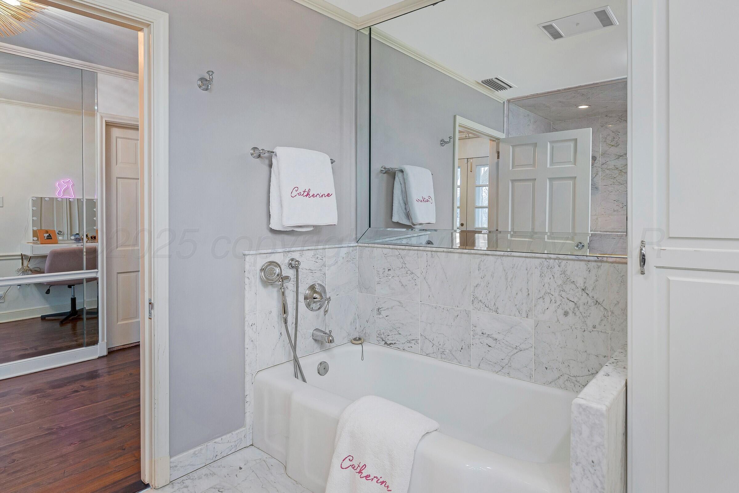 3003 South Hughes Street Amarillo, TX 79109 - Photo 51 of 76 a bathroom with a bathtub and a shower