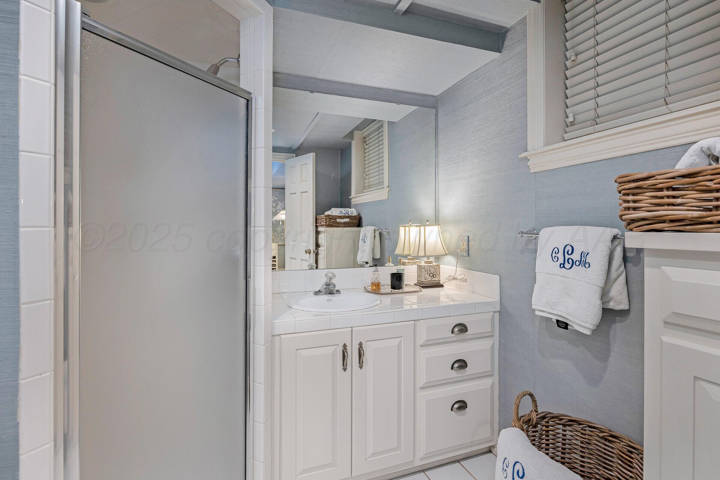 3003 South Hughes Street Amarillo, TX 79109 - Photo 67 of 76 a utility room with cabinets washer and dryer