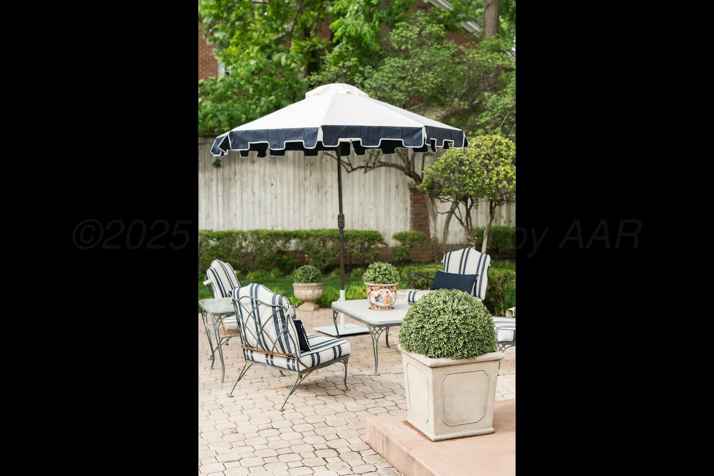 3003 South Hughes Street Amarillo, TX 79109 - Photo 68 of 76 a view of a chair and table with umbrella in the backyard