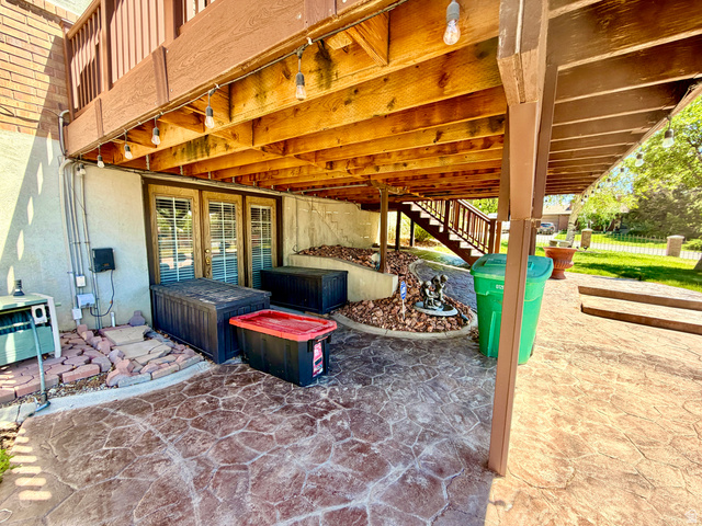 12080 Mill Ridge Circle Sandy, UT 84094 - Photo 38 of 56 Spacious under-deck patio area with stamped concrete flooring
