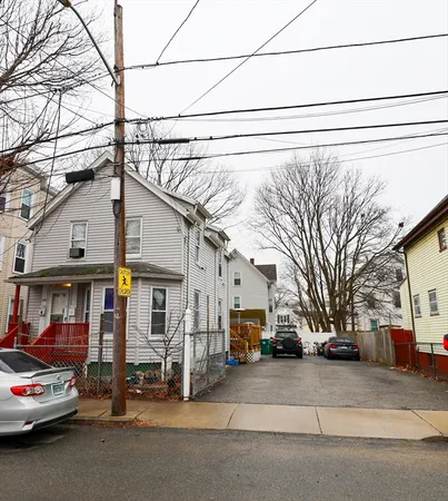 a car parked in front of a white house