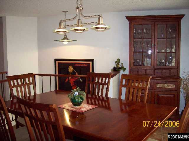 14475 Huron Trail Reno, NV 89521 - Photo 3 of 9 a view of a dining room with furniture wooden floor and chandelier