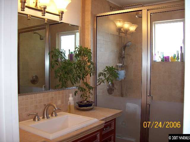 14475 Huron Trail Reno, NV 89521 - Photo 8 of 9 a bathroom with a sink a mirror and a shower