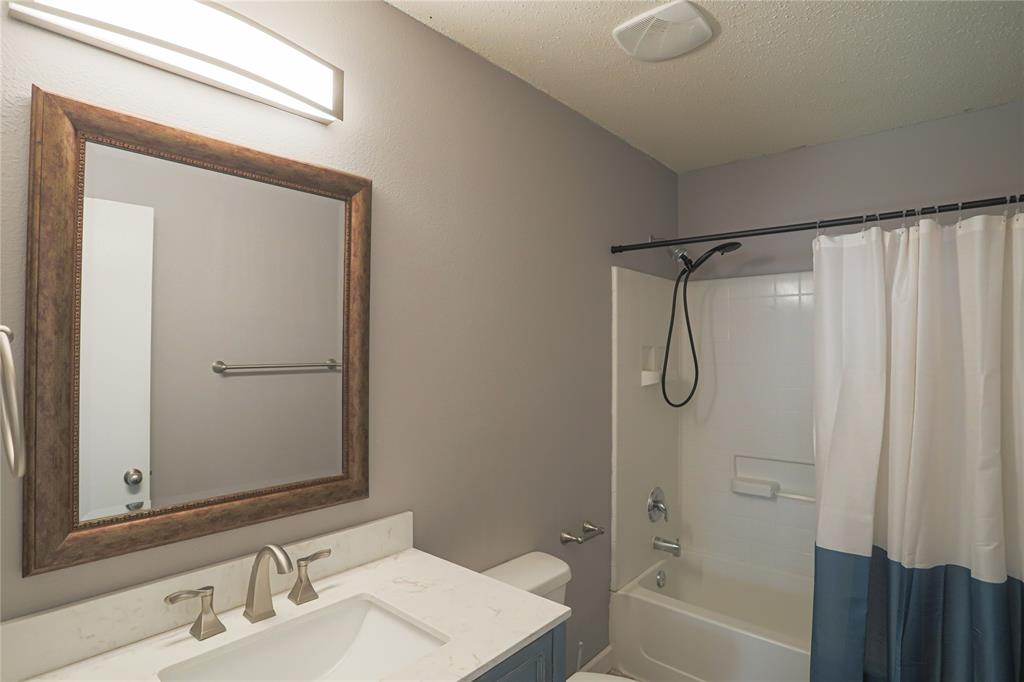 149 Independence Avenue Venus, TX 76084 - Photo 13 of 27 a bathroom with a shower curtain and a sink