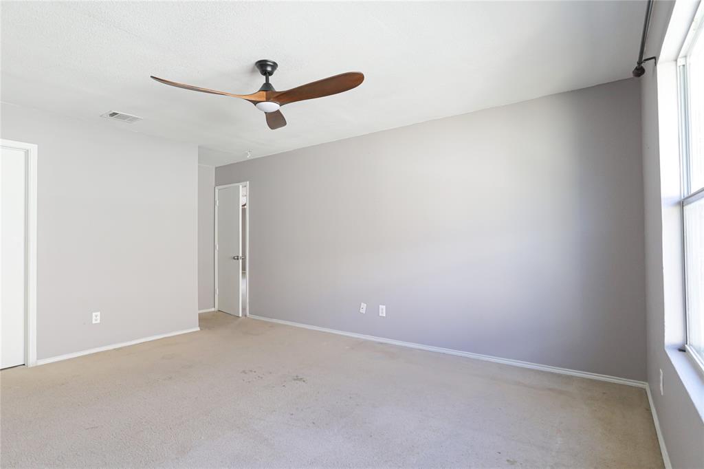 149 Independence Avenue Venus, TX 76084 - Photo 14 of 27 an empty room with a window and a ceiling fan