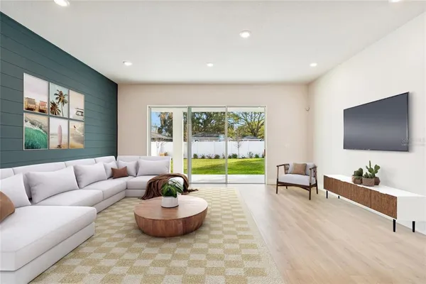 a view of an empty room with wooden floor and a floor to ceiling window
