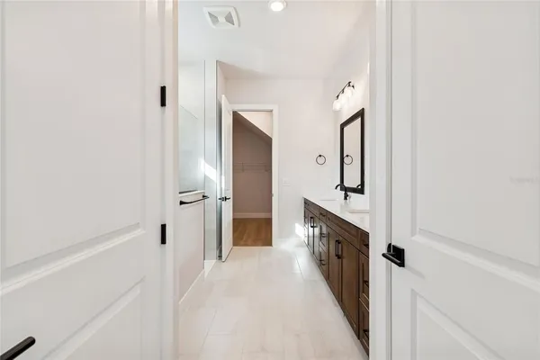 a view of a hallway with wooden floor and entryway