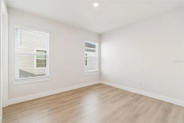 a view of an empty room with wooden floor