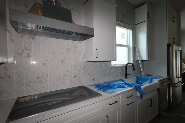 a large en suite bathroom with a tub double sink and window