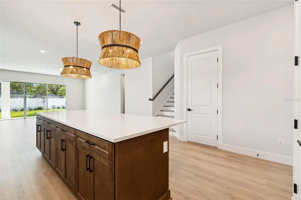 a large kitchen with stainless steel appliances kitchen island granite countertop a large counter top a sink stainless steel appliances and cabinets