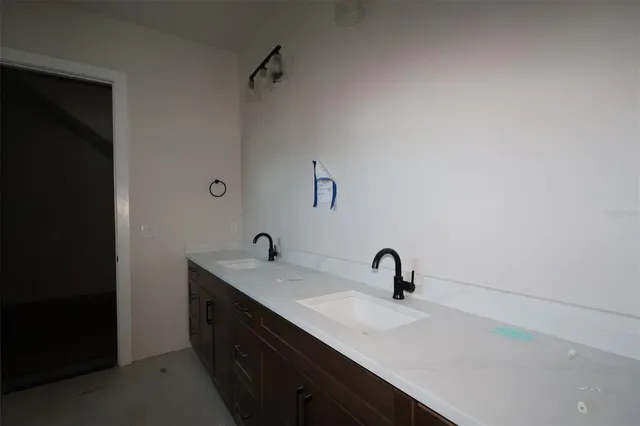 a kitchen with stainless steel appliances granite countertop a sink a refrigerator a stove and a wooden floors