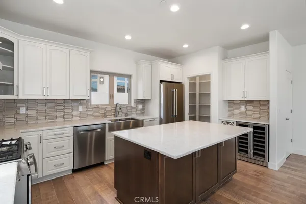 a kitchen with a stove and a white cabinet