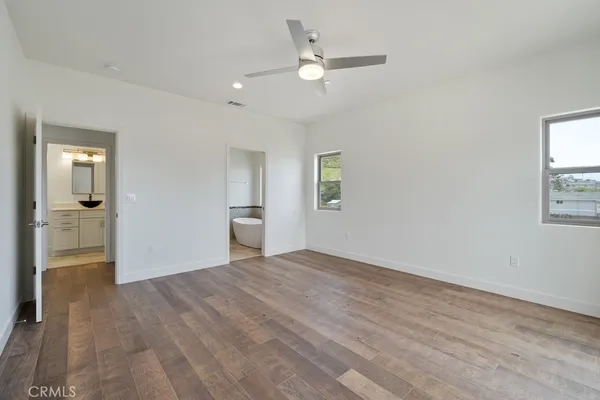 a view of hallway with a large window and wooden floor