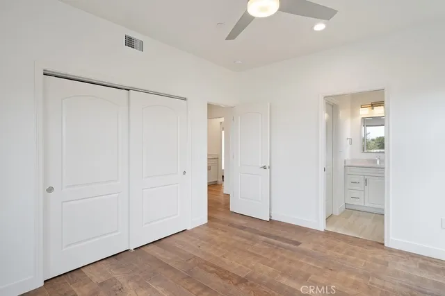 a view of a room with wooden floor