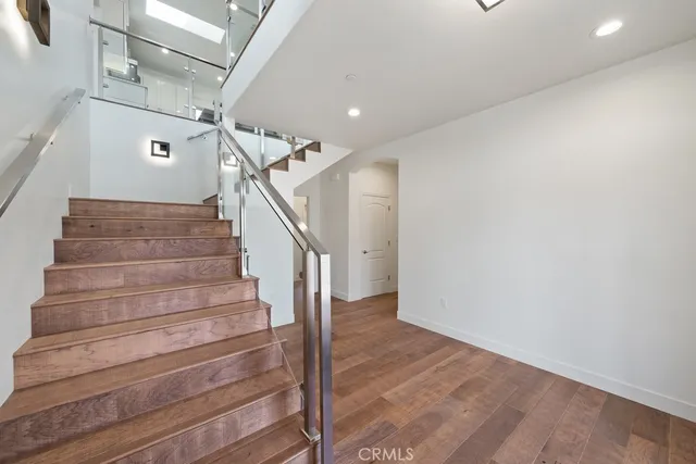 a view of a room with wooden floor and windows