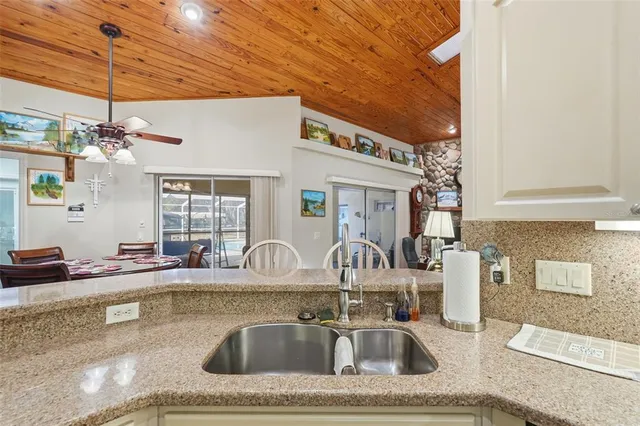 a living room with furniture a flat screen tv and gym equipment