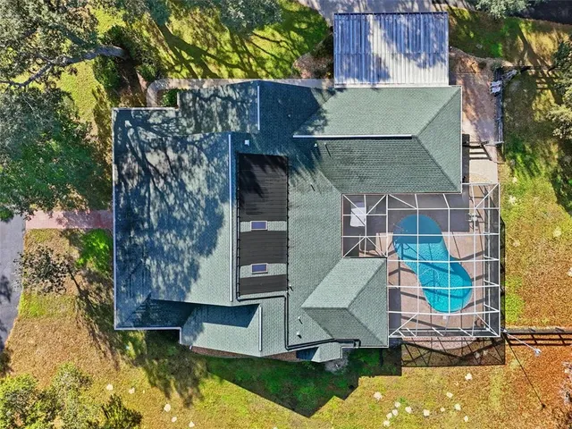 an aerial view of a house with swimming pool