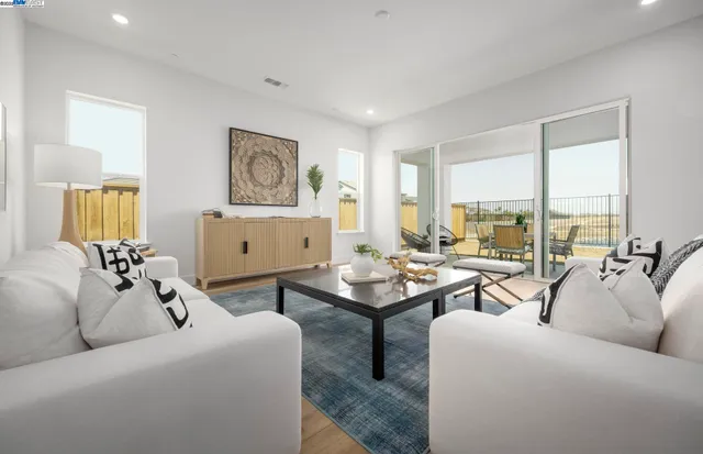 a living room with furniture and floor to ceiling window