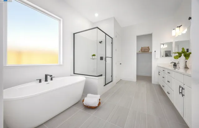 a bathroom with a double vanity sink mirror and shower