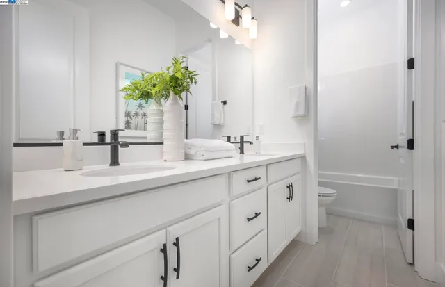 a bathroom with a sink a vanity and a mirror