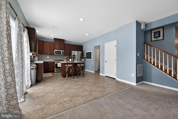 a kitchen with stainless steel appliances a refrigerator and a stove top oven