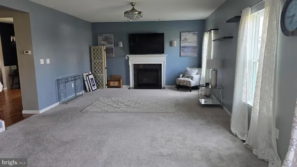 a view of a livingroom with furniture and a fireplace