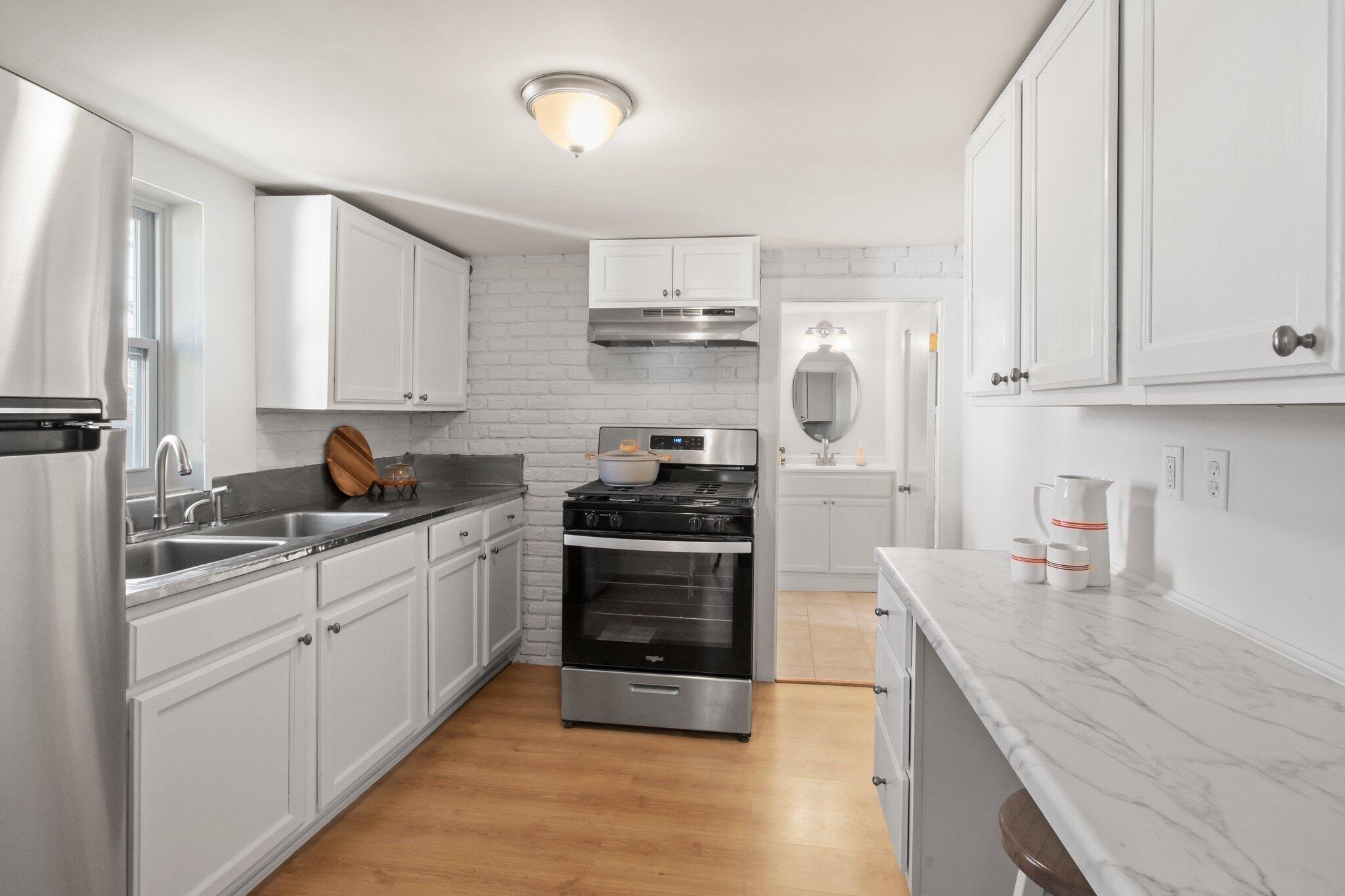 7 Spruce Street Fairhaven, MA 02719 - Photo 11 of 30 a kitchen with cabinets and stainless steel appliances