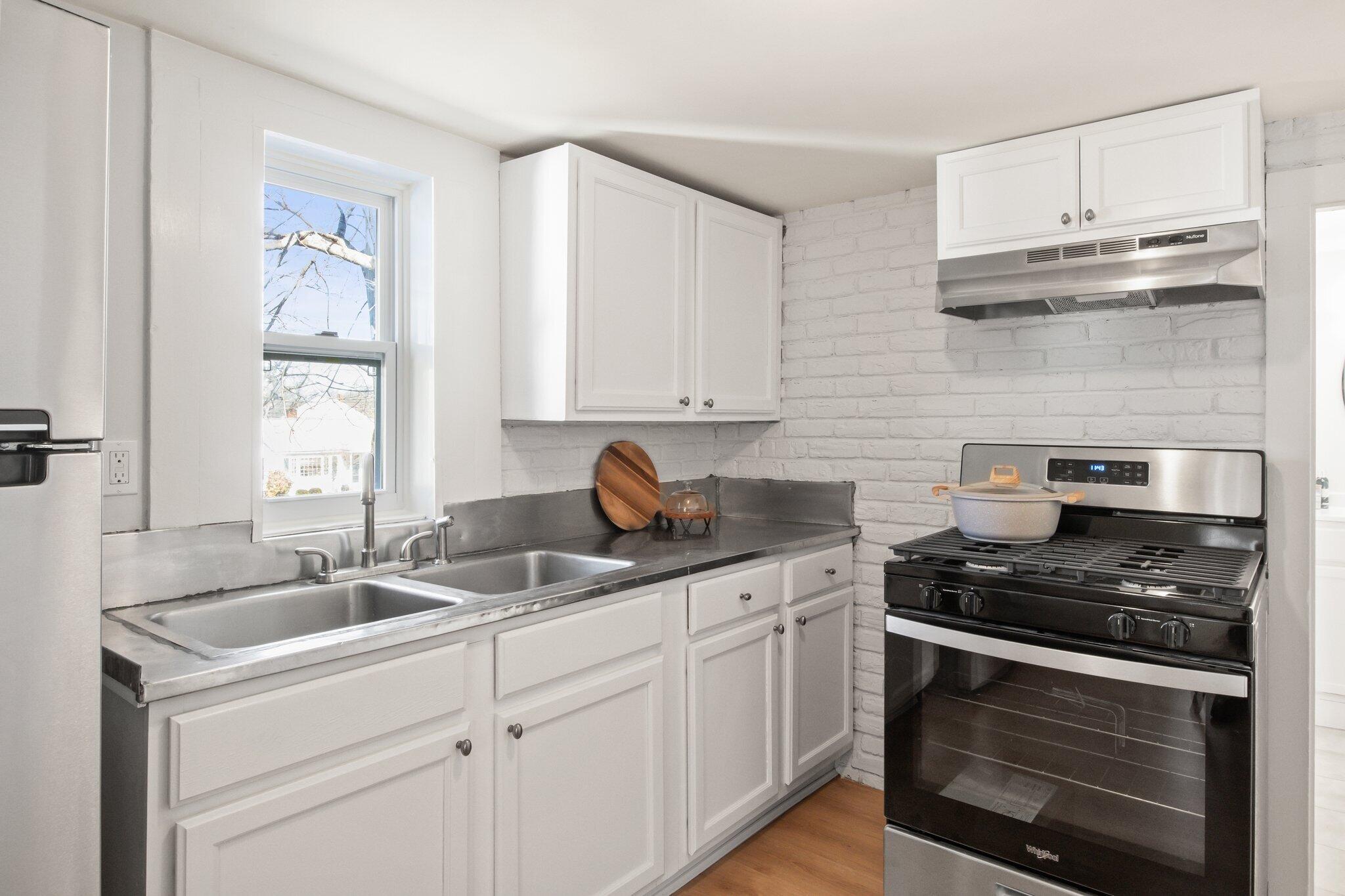 7 Spruce Street Fairhaven, MA 02719 - Photo 12 of 30 a kitchen with cabinets stainless steel appliances and a sink