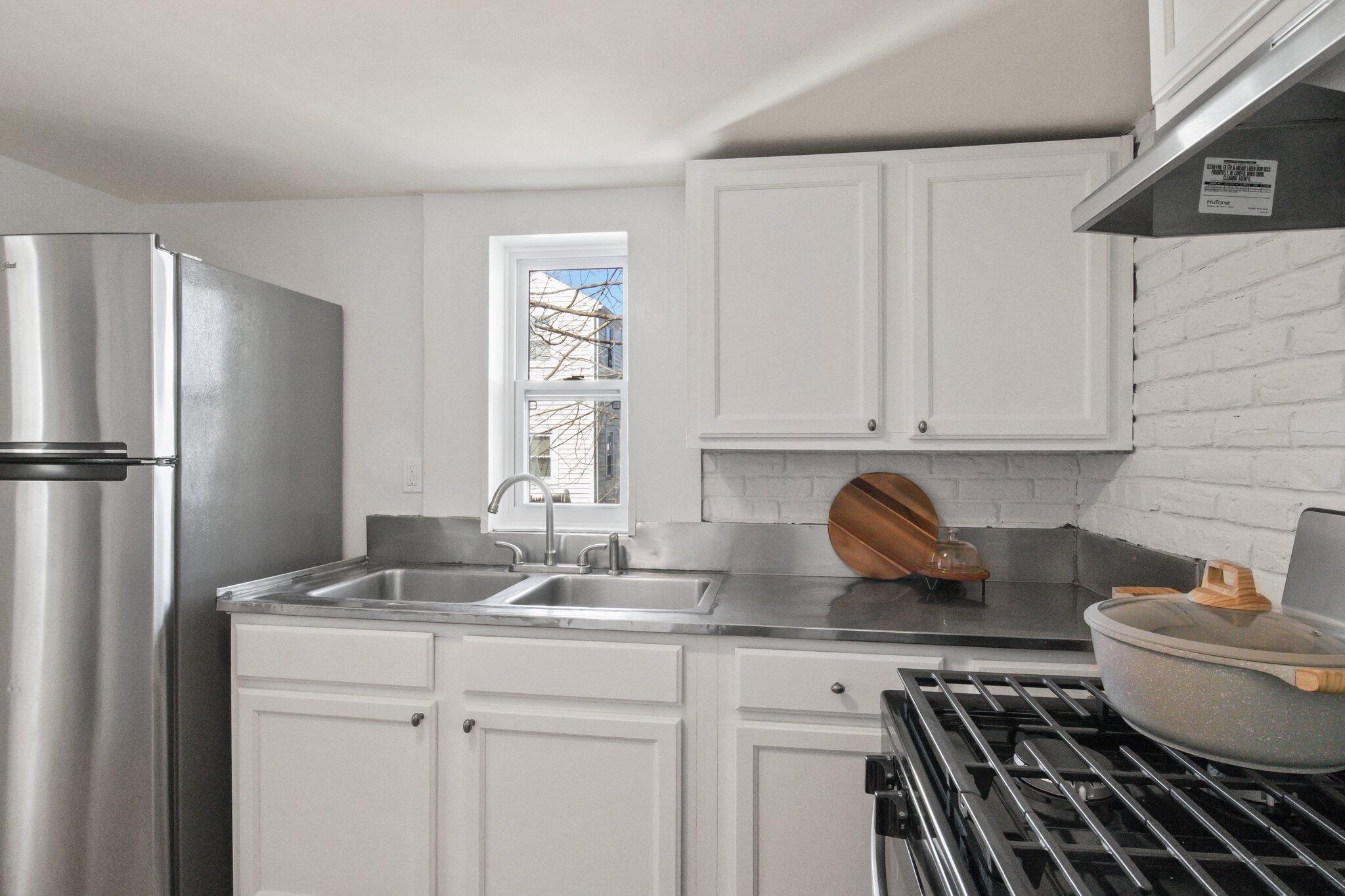7 Spruce Street Fairhaven, MA 02719 - Photo 14 of 30 a kitchen with stainless steel appliances granite countertop a sink stove and refrigerator