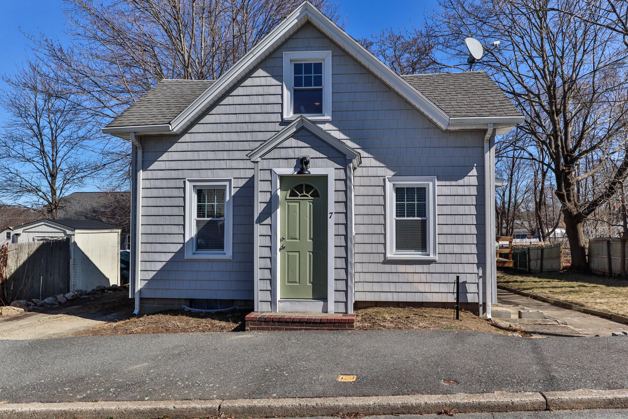 7 Spruce Street Fairhaven, MA 02719 - Photo 2 of 30 a front view of a house with a garage