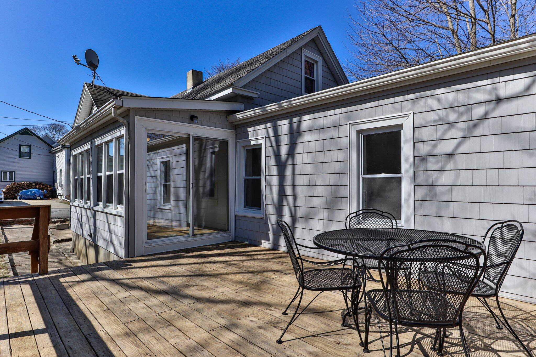 7 Spruce Street Fairhaven, MA 02719 - Photo 27 of 30 a patio with table and chairs and potted plants