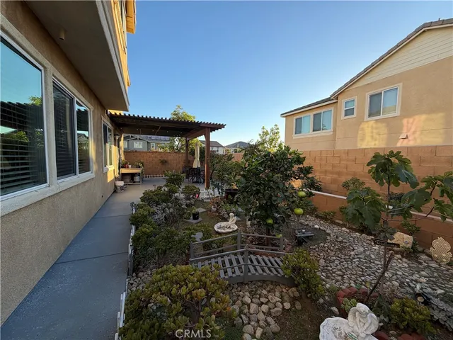 a view of backyard with plants and outdoor seating
