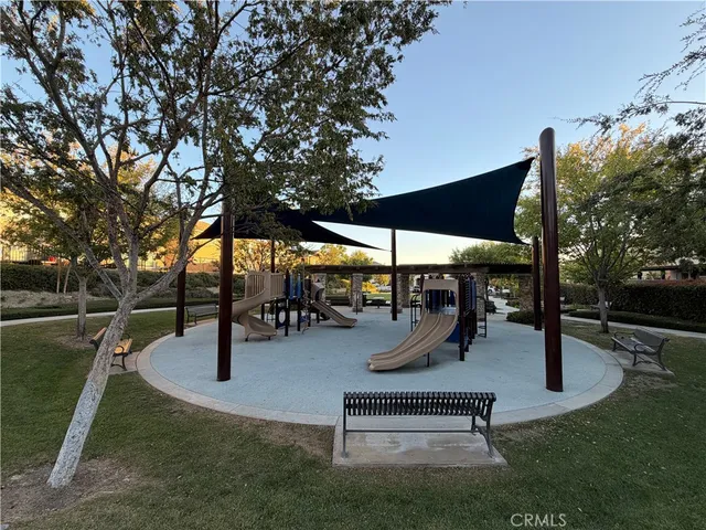 a view of field with grass and trees in the background