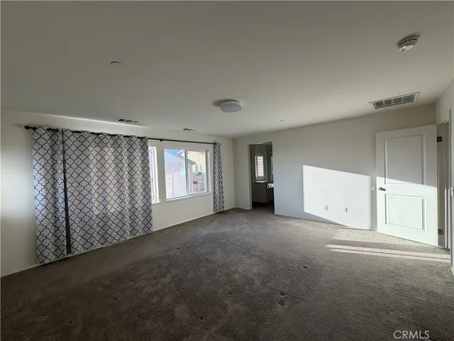 a spacious bathroom with a tub sink and mirror
