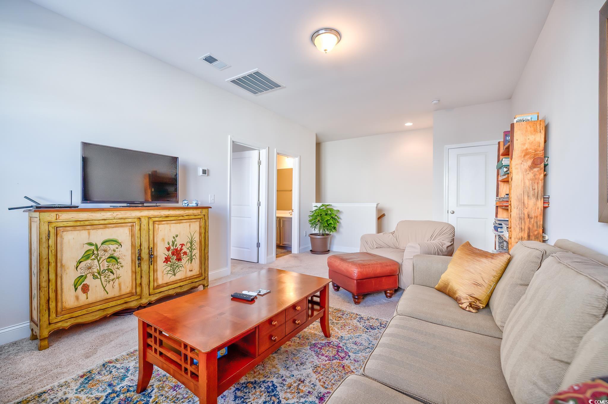 2052 Silver Island Way Murrells Inlet, SC 29576 - Photo 17 of 24 Carpeted living room featuring recessed lighting and baseboards