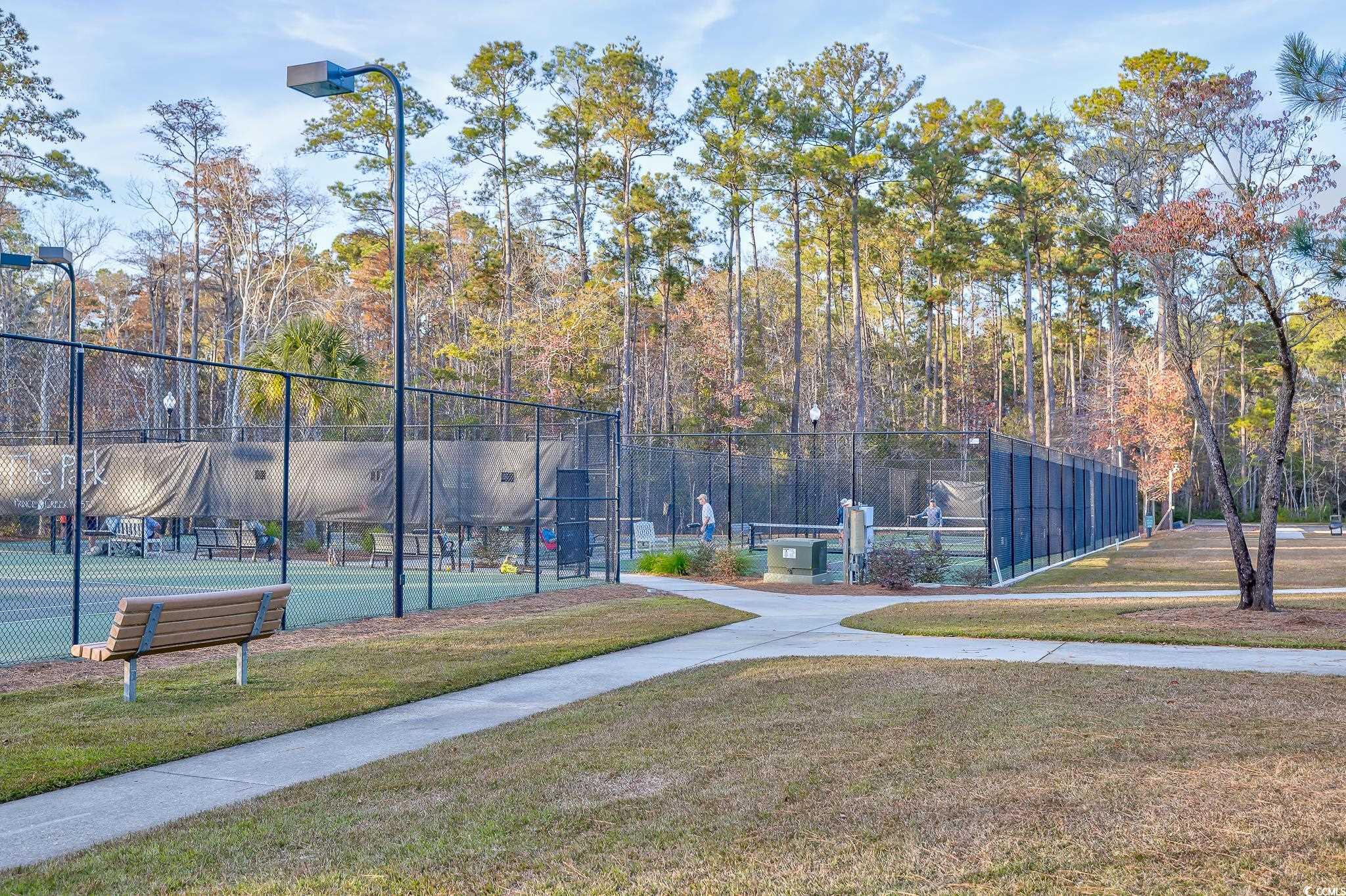 View of community with a tennis court