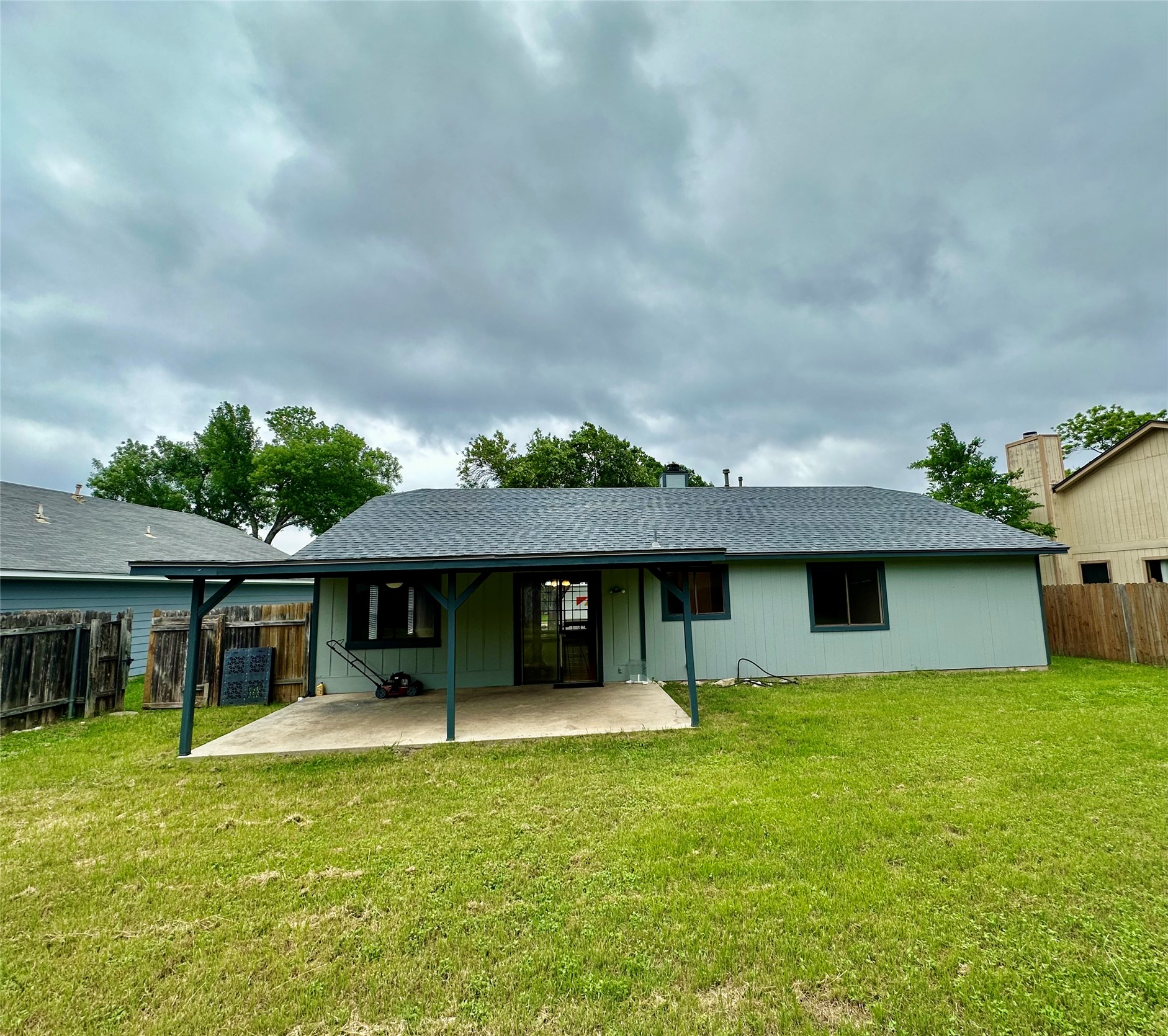 709 Brookside Pass Cedar Park, TX 78613 - Photo 10 of 10 The property features a spacious backyard with a well-maintained lawn and a covered patio