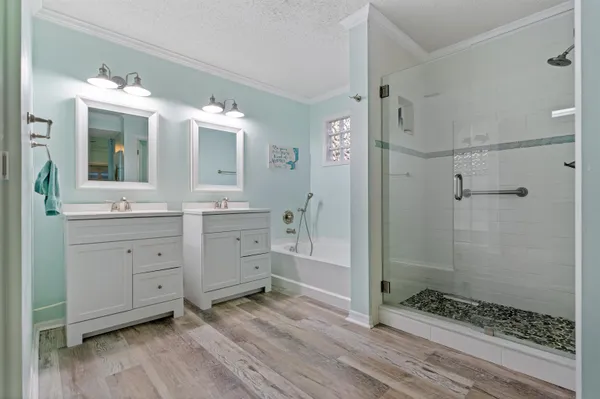 a bathroom with a double vanity sink toilet and shower