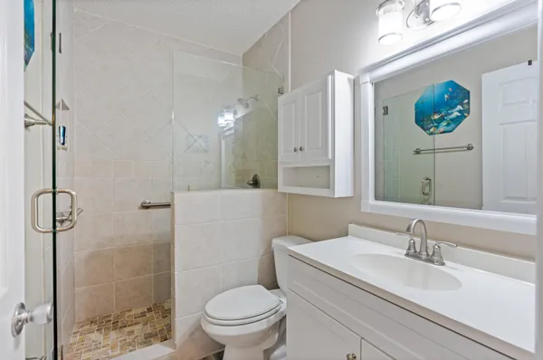 a bathroom with a sink toilet and shower