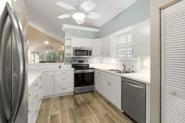 a kitchen with stainless steel appliances a sink stove and refrigerator