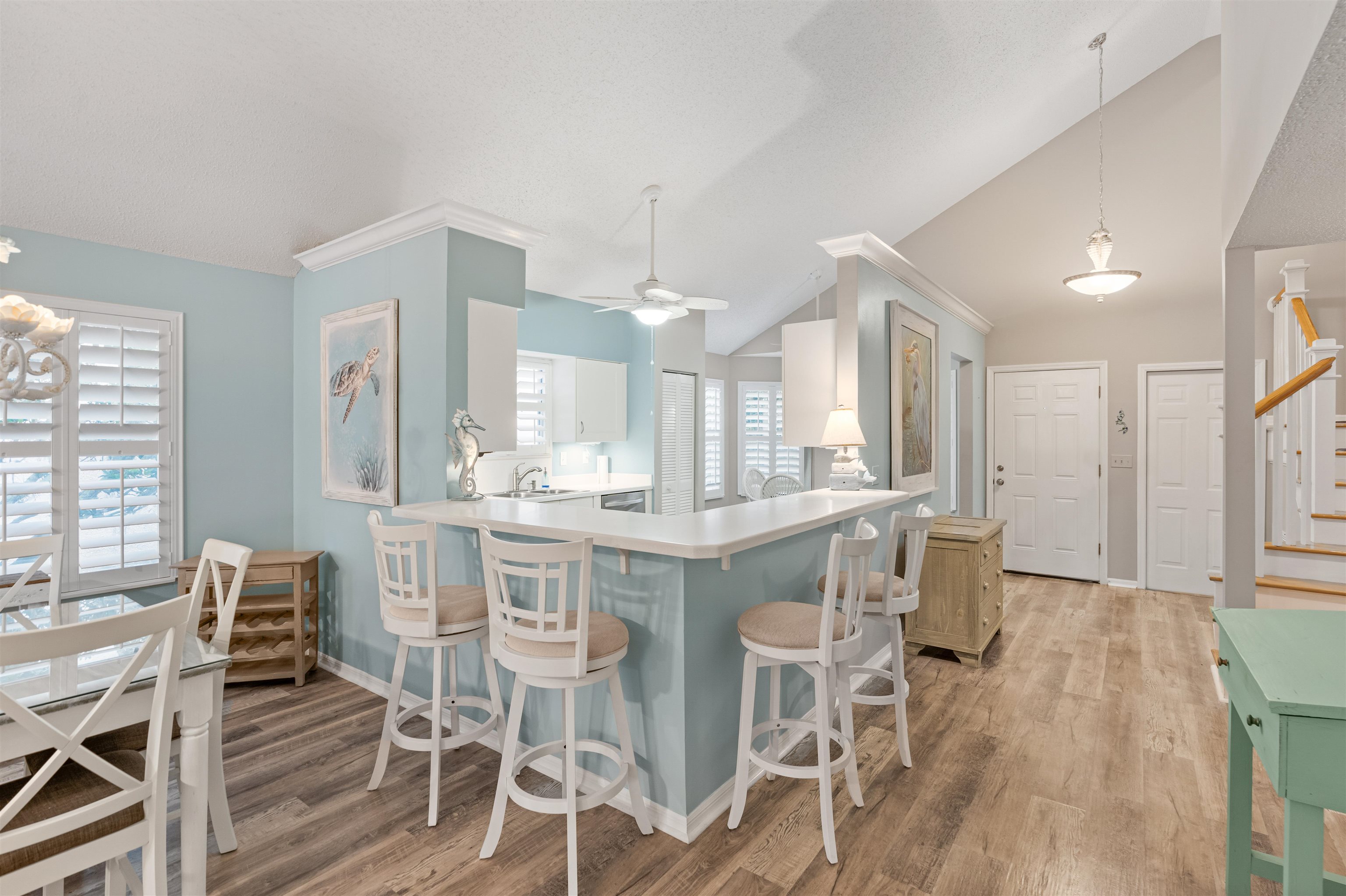 362 Monika Place St. Augustine, FL 32080 - Photo 6 of 42 a kitchen with stainless steel appliances kitchen island granite countertop a dining table chairs and granite counter tops