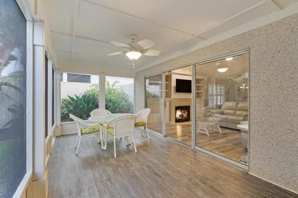 a dining room with furniture a fireplace and wooden floor