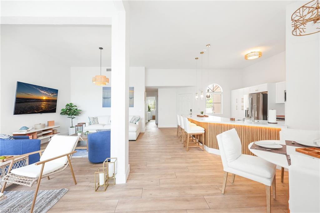 2711 Citrus Lake Drive, Unit F305 Naples, FL 34109 - Photo 20 of 50 a living room with furniture and a flat screen tv