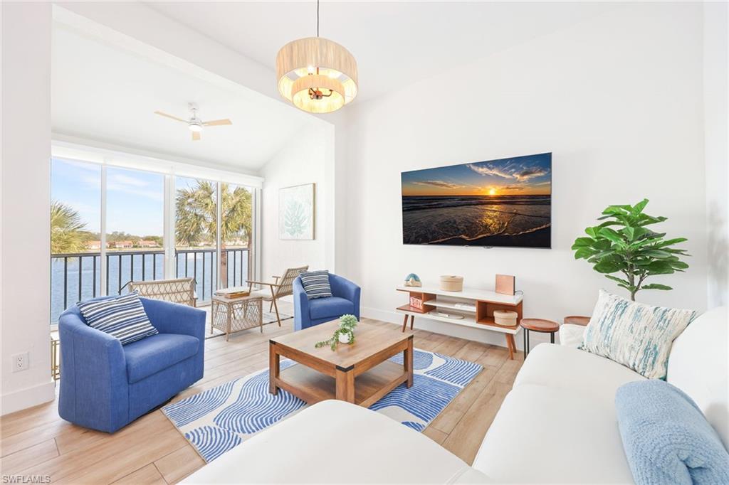 2711 Citrus Lake Drive, Unit F305 Naples, FL 34109 - Photo 2 of 50 a living room with furniture and a flat screen tv