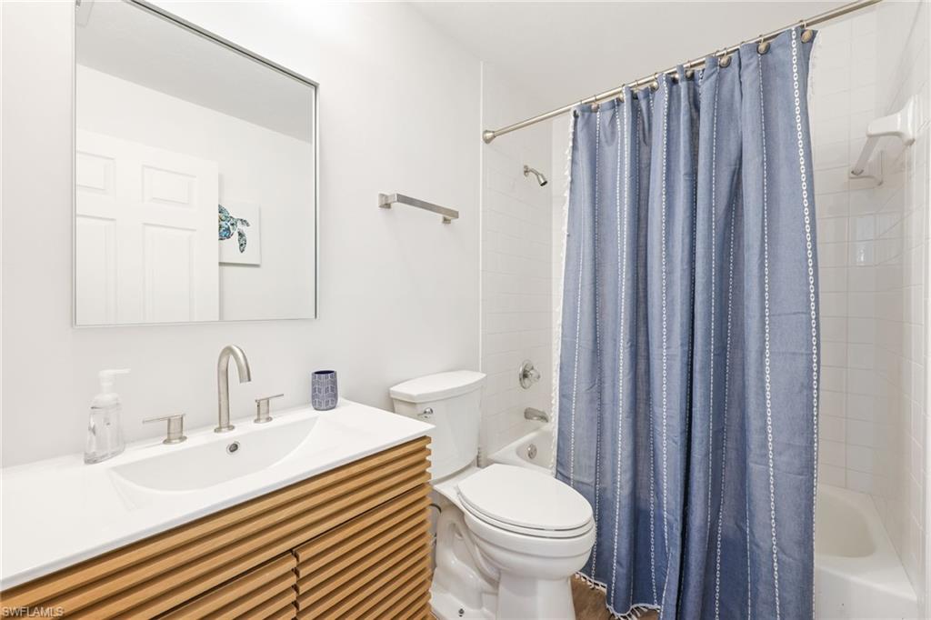 2711 Citrus Lake Drive, Unit F305 Naples, FL 34109 - Photo 30 of 50 a bathroom with a sink a toilet and shower